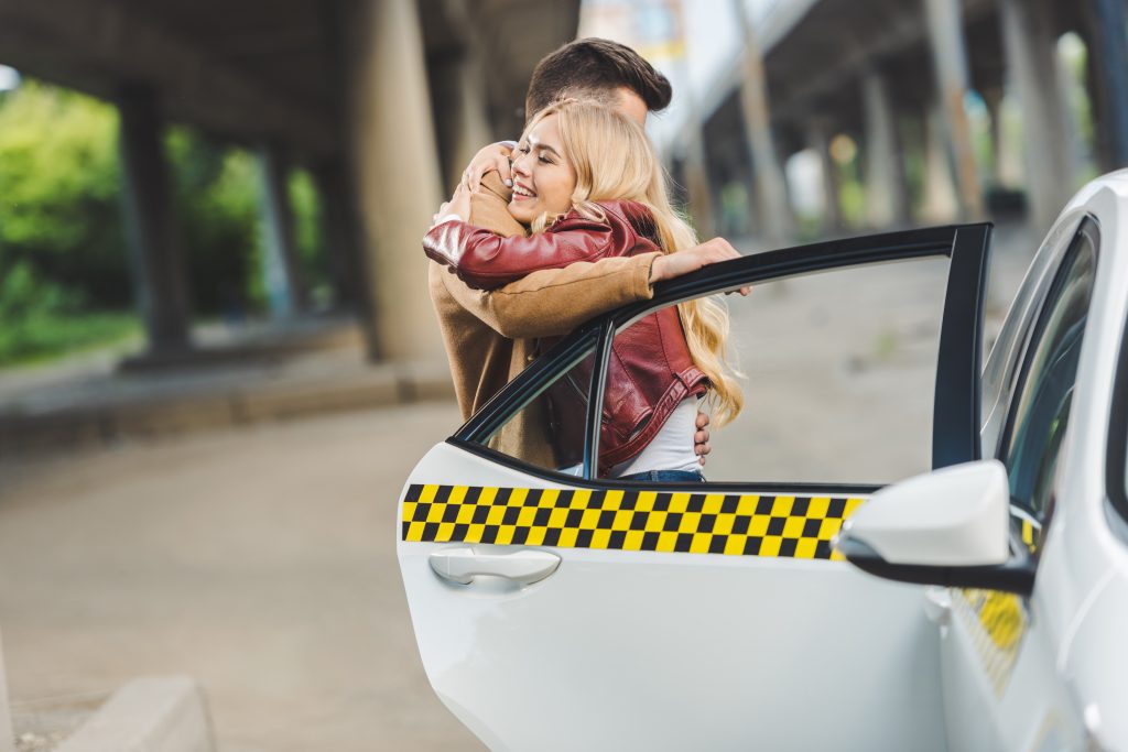 beautiful-young-couple-hugging-near-taxi-cab-2023-11-27-05-21-42-utc